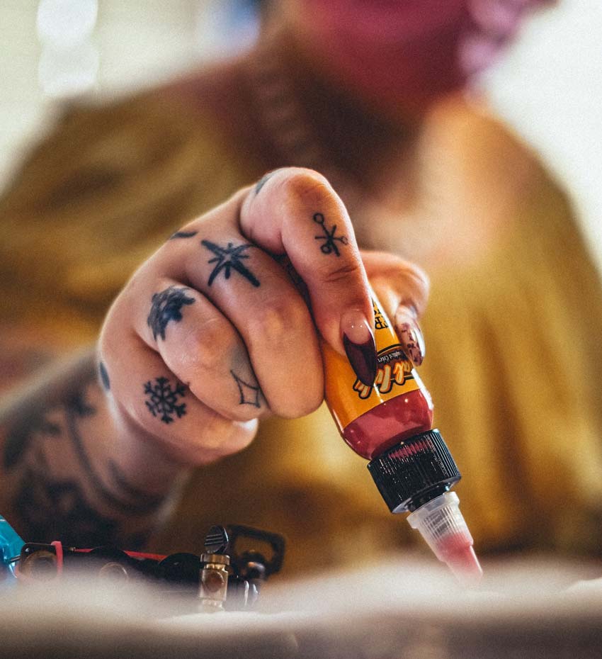 Tattooed Hand Squeezing out Ink Tattooed Hand Squeezing out Ink
